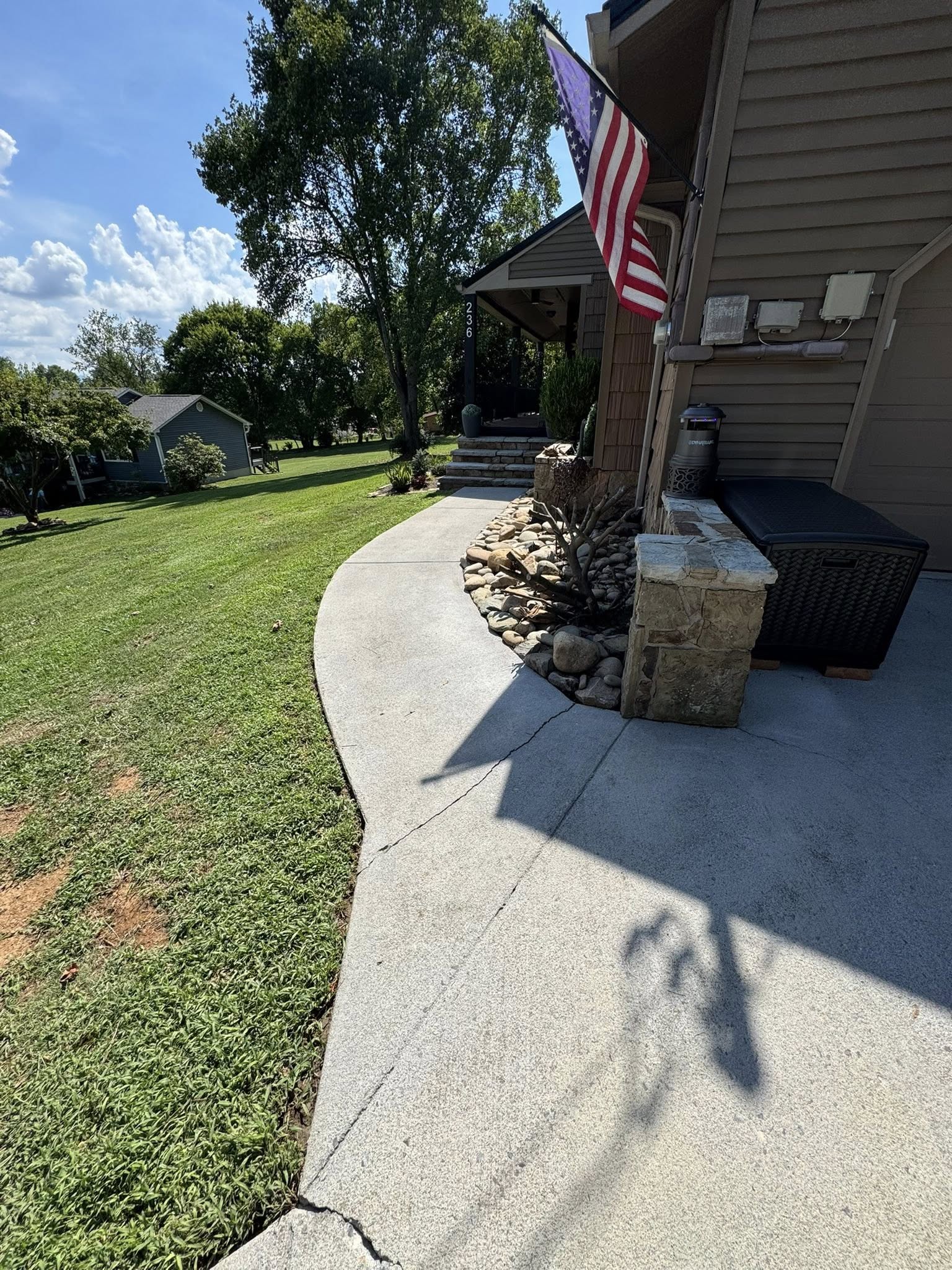 Clean driveway and house exterior after professional washing