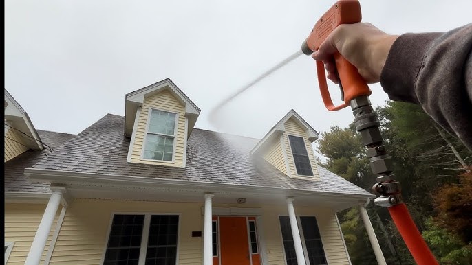 Roof washing equipment beside a property