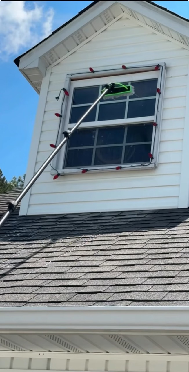 Exterior window being cleaned with a water-fed pole